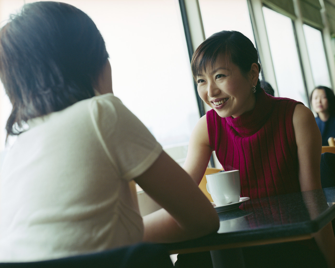 Asian Women Chatting over Coffee