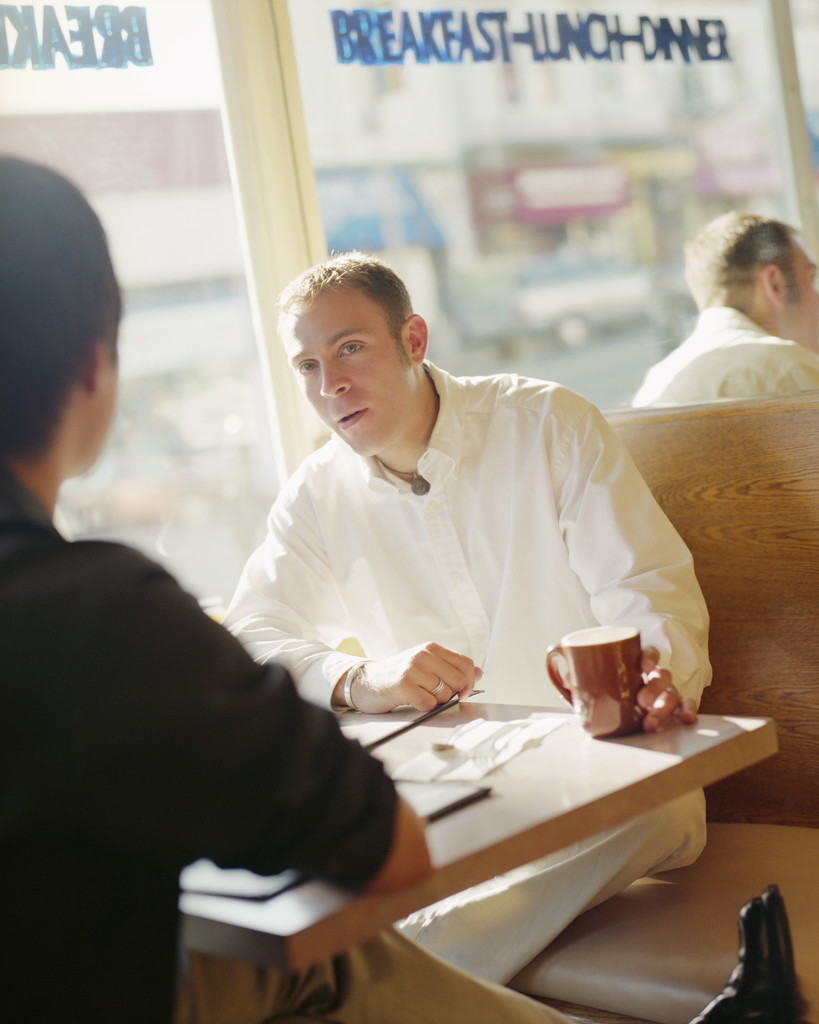 Two Men Talking in Restaurant