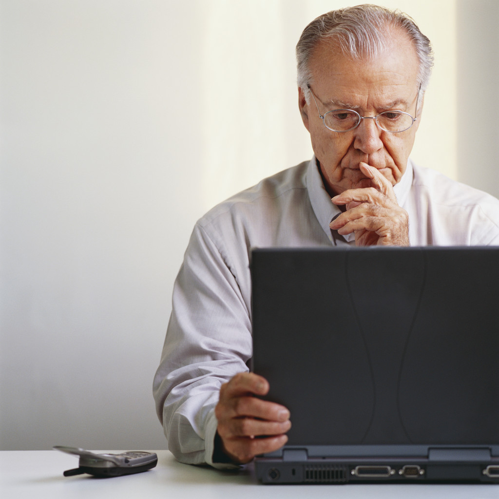 Pensive Businessman Using Laptop