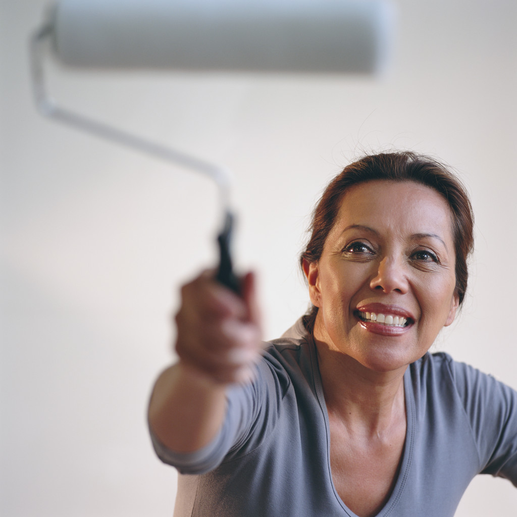 Woman Painting with a Paint Roller