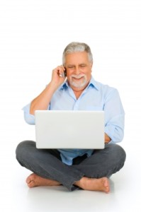 ambro older man on laptop and cell phone